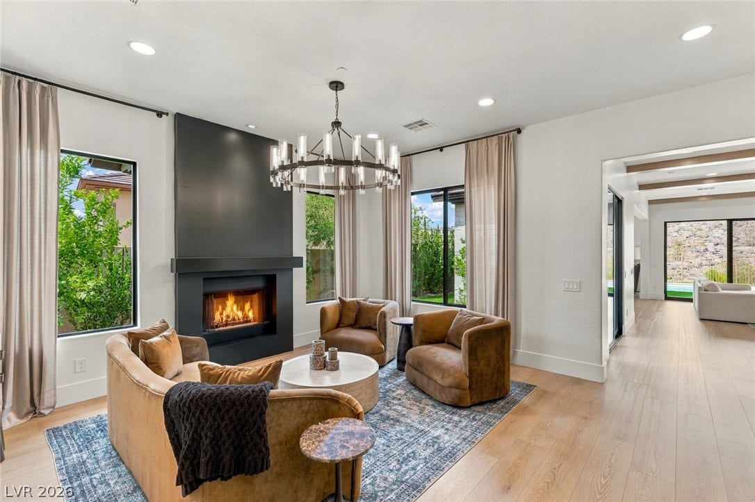 40 Stonemark Drive, Henderson, NV 89052 A modern fireplace serves as the centerpiece of this light-filled room with wide-plank hardwood flooring.