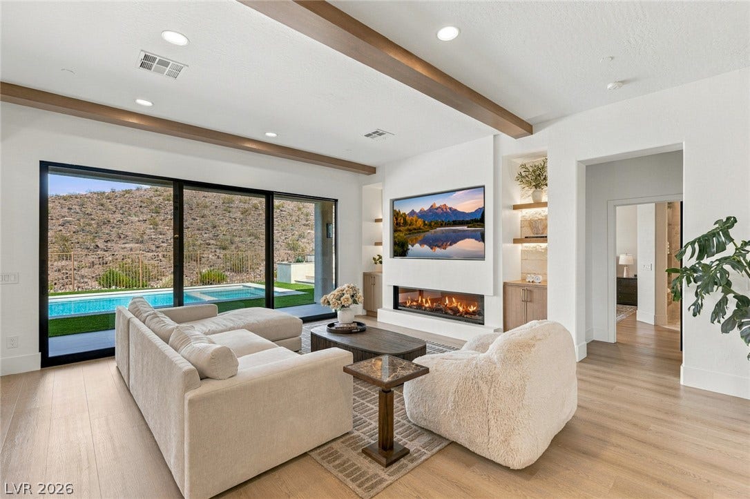 40 Stonemark Drive, Henderson, NV 89052 Exposed ceiling beams and wide sliding glass doors frame tranquil pool and desert views.