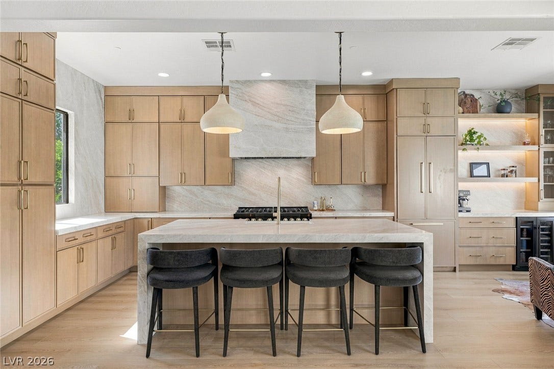 40 Stonemark Drive, Henderson, NV 89052 Fine cabinetry and sleek stone surfaces define this modern culinary workspace.