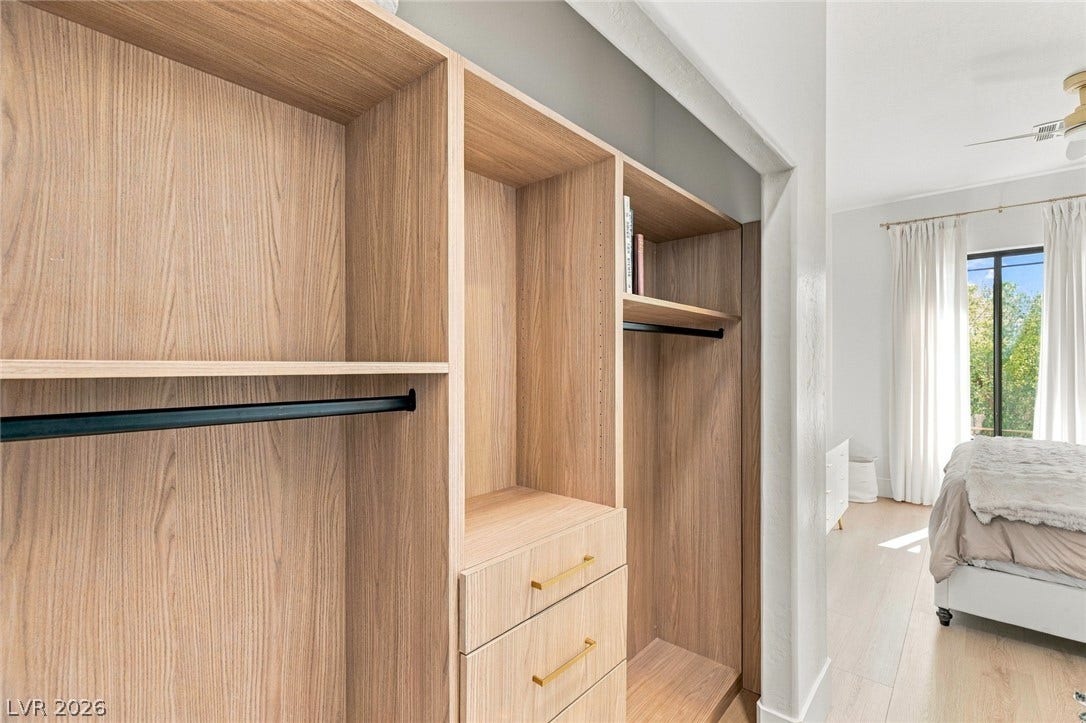 40 Stonemark Drive, Henderson, NV 89052 Custom built-in shelving and storage systems elevate this functional walk-in closet design.