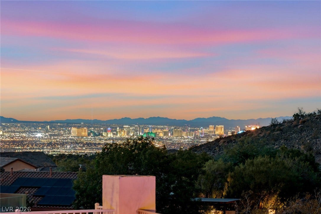 40 Stonemark Drive, Henderson, NV 89052 Sweeping mountain and city skyline panoramas unfold beneath vibrant twilight skies.