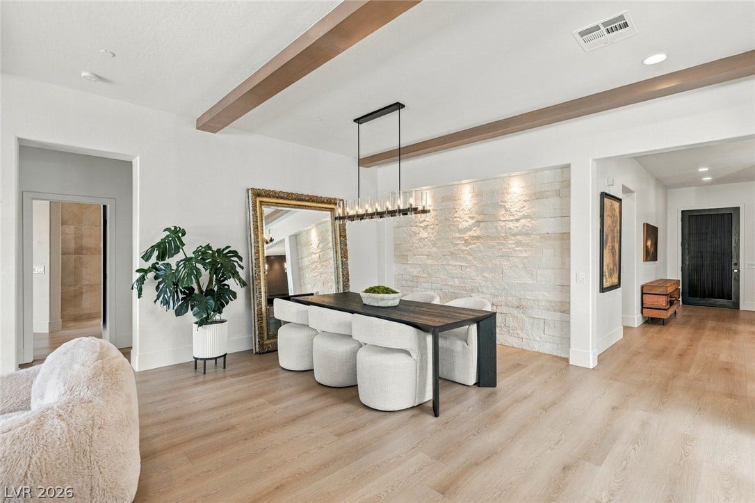40 Stonemark Drive, Henderson, NV 89052 Exquisite wood ceiling beams complement the light oak flooring and stone accent wall.