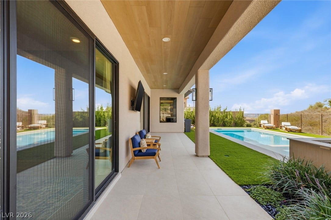 40 Stonemark Drive, Henderson, NV 89052 A spacious covered patio with tile flooring and wood ceiling overlooks the sparkling pool area.
