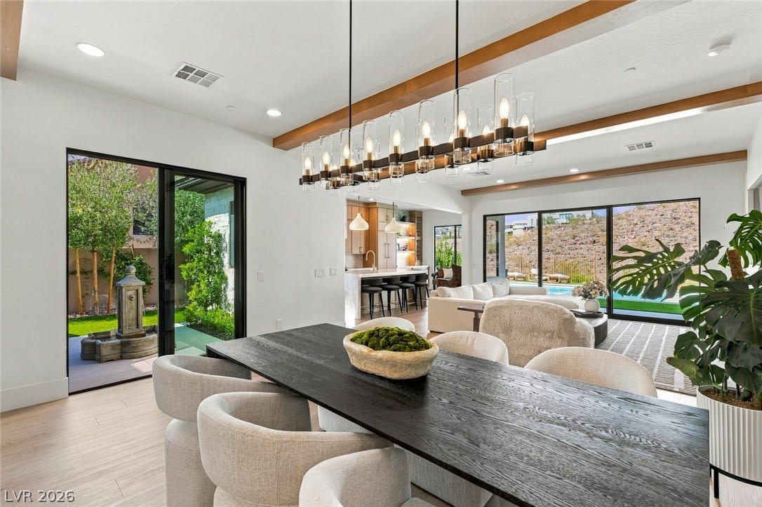 40 Stonemark Drive, Henderson, NV 89052 Rich wood beams, modern lighting, and glass doors highlight this open dining area.