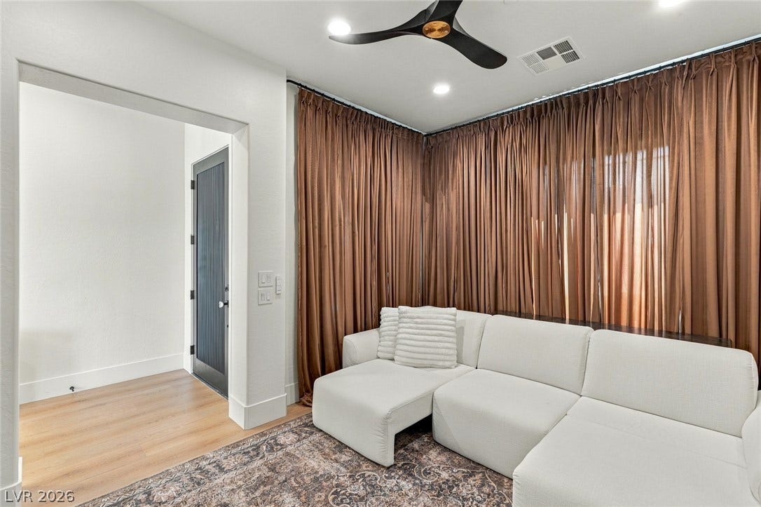 40 Stonemark Drive, Henderson, NV 89052 Gleaming hardwood floors and clean plaster walls define this comfortable modern living area.