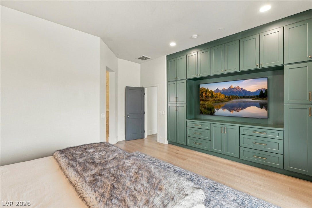 40 Stonemark Drive, Henderson, NV 89052 An integrated media wall anchors this modern bedroom retreat with clean architectural lines.
