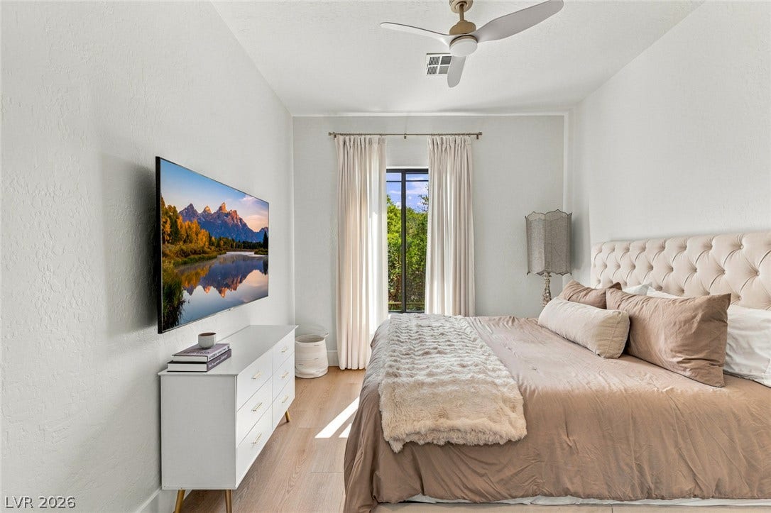 40 Stonemark Drive, Henderson, NV 89052 Smooth plaster walls and warm hardwood floors define this inviting secondary bedroom retreat.