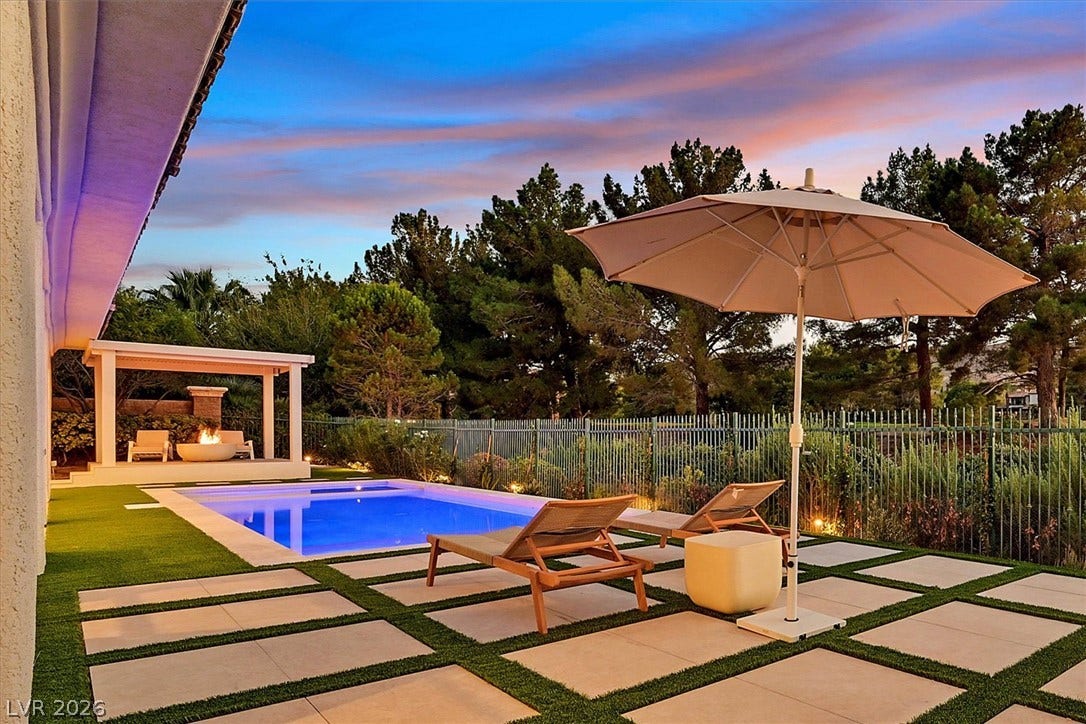 12007 Oakland Hills Drive, Las Vegas, NV 89141 Lush landscaping surrounds a sparkling in-ground pool and an elegant modern patio design.