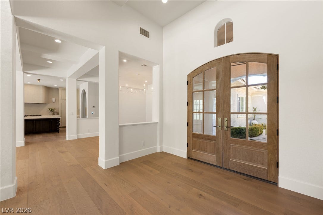 12007 Oakland Hills Drive, Las Vegas, NV 89141 Double glass doors open into a bright entryway with wide-plank wood flooring.