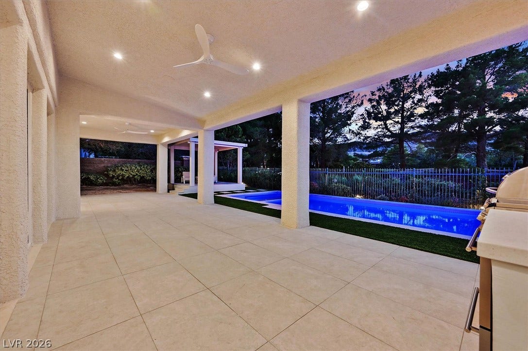 12007 Oakland Hills Drive, Las Vegas, NV 89141 Tiled flooring extends across a covered outdoor area overlooking the pool and yard.