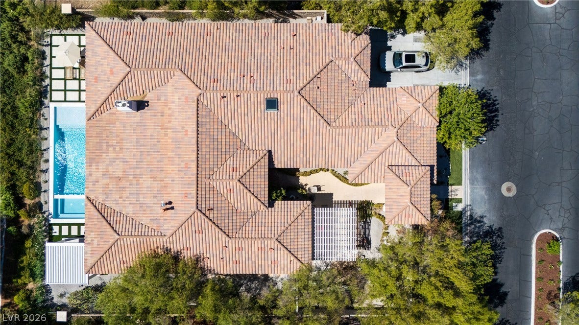 12007 Oakland Hills Drive, Las Vegas, NV 89141 An aerial perspective showcases the tiled roofline and private backyard pool of this elegant residence.