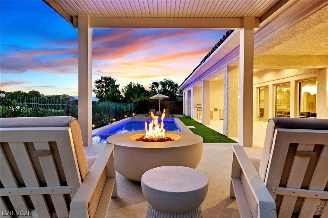 12007 Oakland Hills Drive, Las Vegas, NV 89141 A covered patio with a modern fire pit overlooks the glistening pool.
