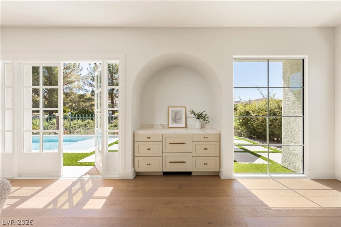 12007 Oakland Hills Drive, Las Vegas, NV 89141 French doors open to the pool area, framing a beautiful arched built-in buffet niche.