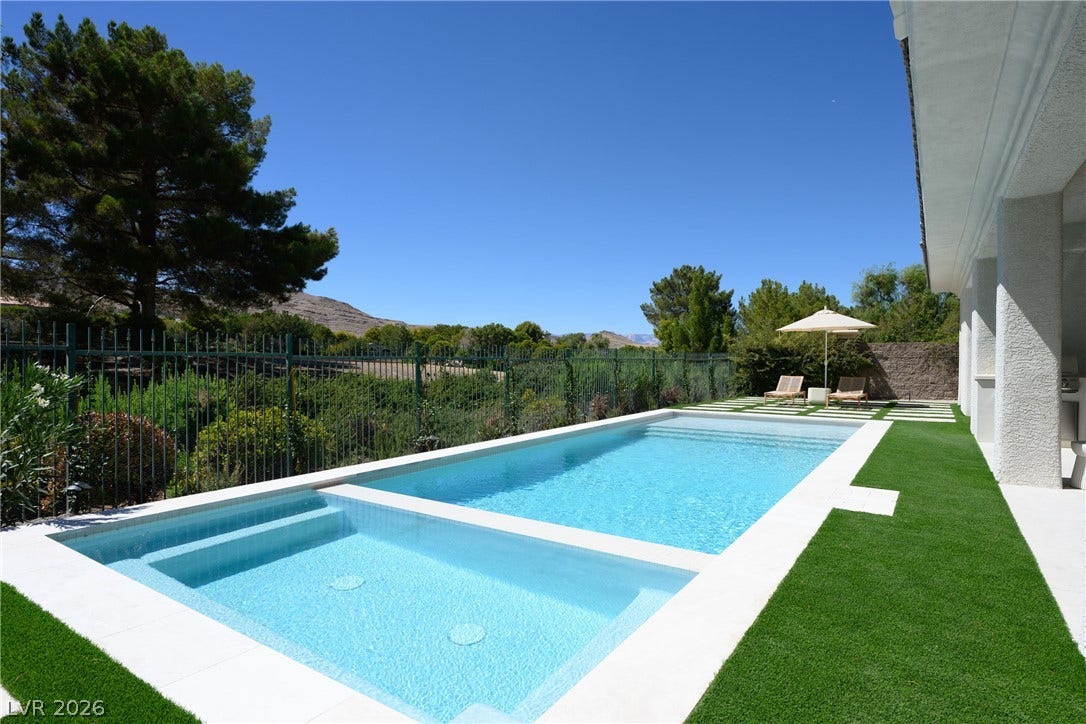 12007 Oakland Hills Drive, Las Vegas, NV 89141 An inviting swimming pool and spa are set against a backdrop of rolling hills.