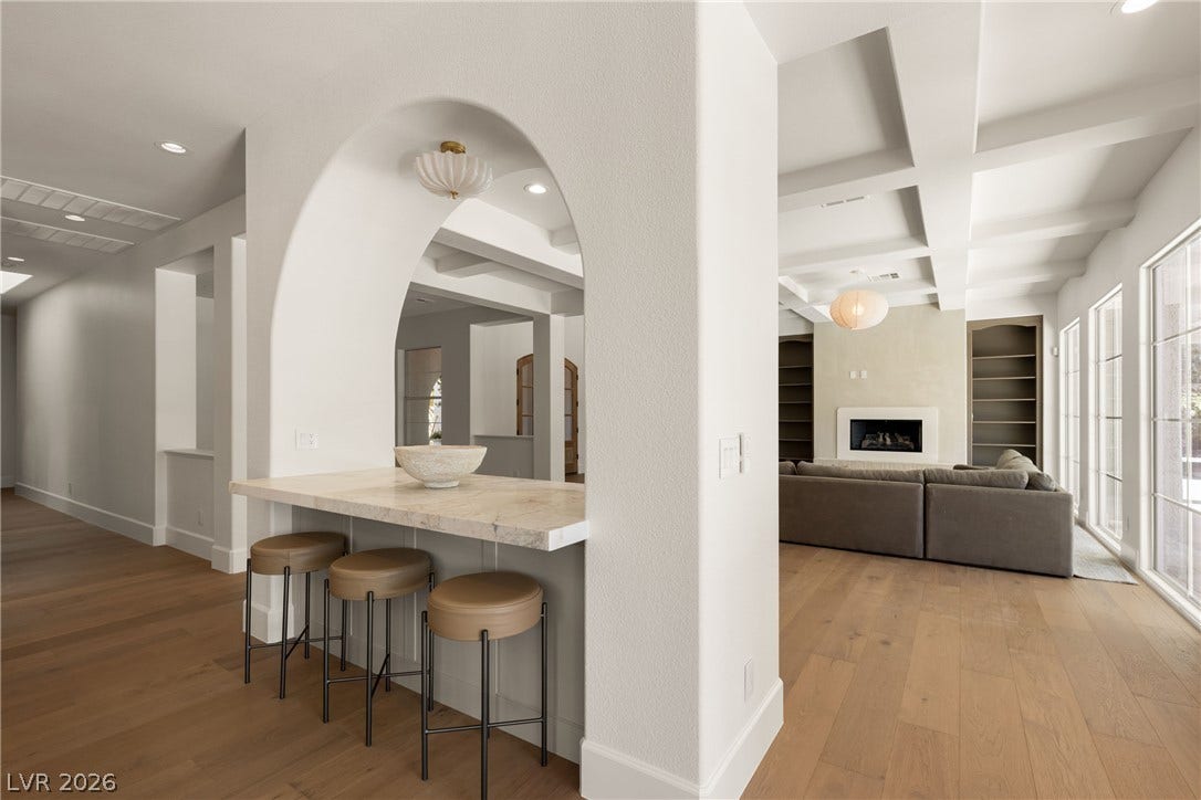 12007 Oakland Hills Drive, Las Vegas, NV 89141 Gleaming hardwood floors and an elegant arched opening frame this integrated modern living space.