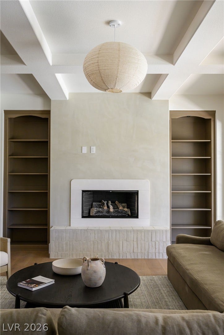12007 Oakland Hills Drive, Las Vegas, NV 89141 An elegant fireplace with a tiled hearth sits anchored between built-in bookcases.