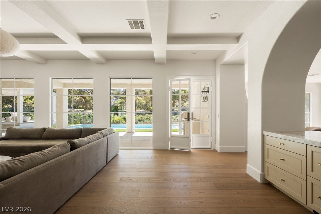 12007 Oakland Hills Drive, Las Vegas, NV 89141 Gleaming hardwood floors and a coffered ceiling define this open-concept living area.
