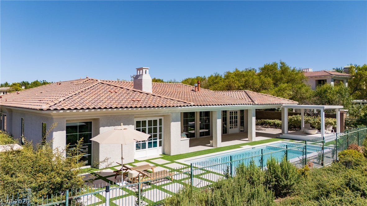 12007 Oakland Hills Drive, Las Vegas, NV 89141 Spanish tile roofing and custom stonework details highlight this inviting backyard oasis.