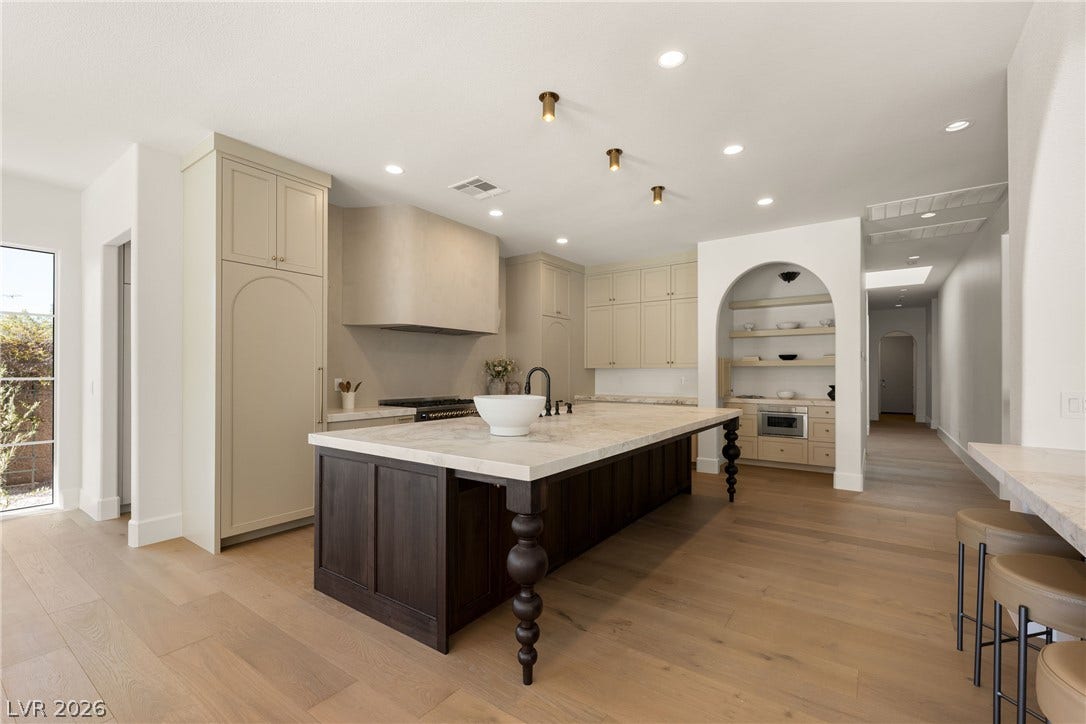 12007 Oakland Hills Drive, Las Vegas, NV 89141 A spacious kitchen features wood flooring and a large island with stone countertops.