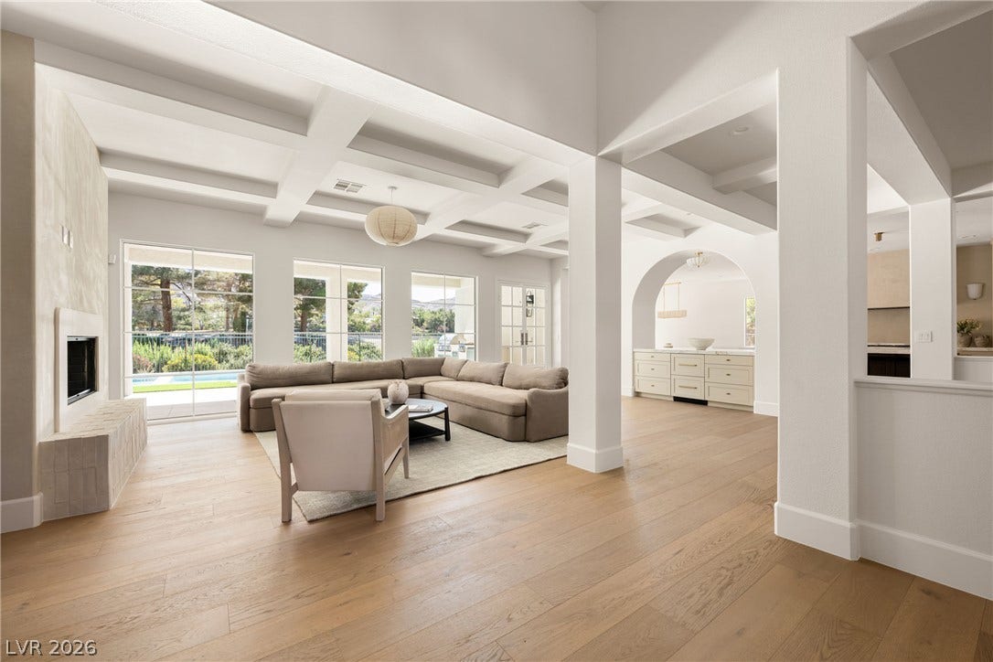 12007 Oakland Hills Drive, Las Vegas, NV 89141 Exposed ceiling beams and light wood flooring elevate this airy open-concept living space.
