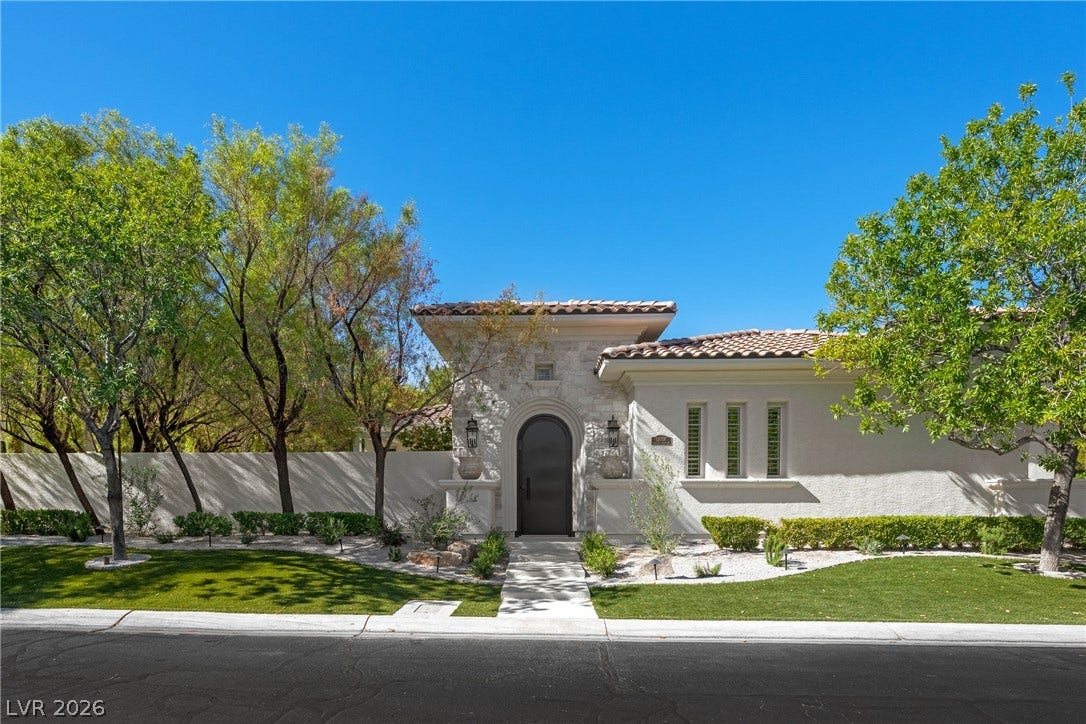 12007 Oakland Hills Drive, Las Vegas, NV 89141 An arched entry and stone tower details create an inviting curb appeal.
