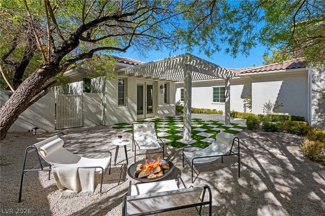 12007 Oakland Hills Drive, Las Vegas, NV 89141 Mature trees shade a beautifully paved courtyard complete with an elegant overhead pergola structure.
