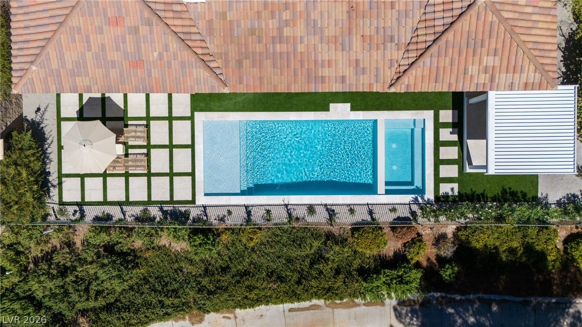12007 Oakland Hills Drive, Las Vegas, NV 89141 An aerial perspective showcases a pristine swimming pool and spa alongside a tile roof.