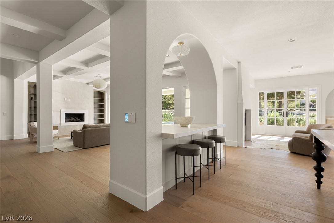 12007 Oakland Hills Drive, Las Vegas, NV 89141 Graceful archways and beamed ceilings highlight this open, light-filled main level with handsome wood flooring.