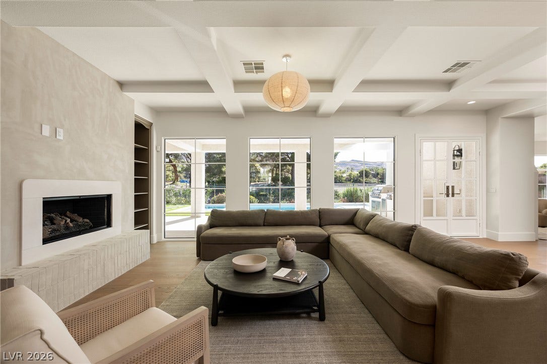 12007 Oakland Hills Drive, Las Vegas, NV 89141 A striking coffered ceiling and sleek fireplace define this elegant modern living area.