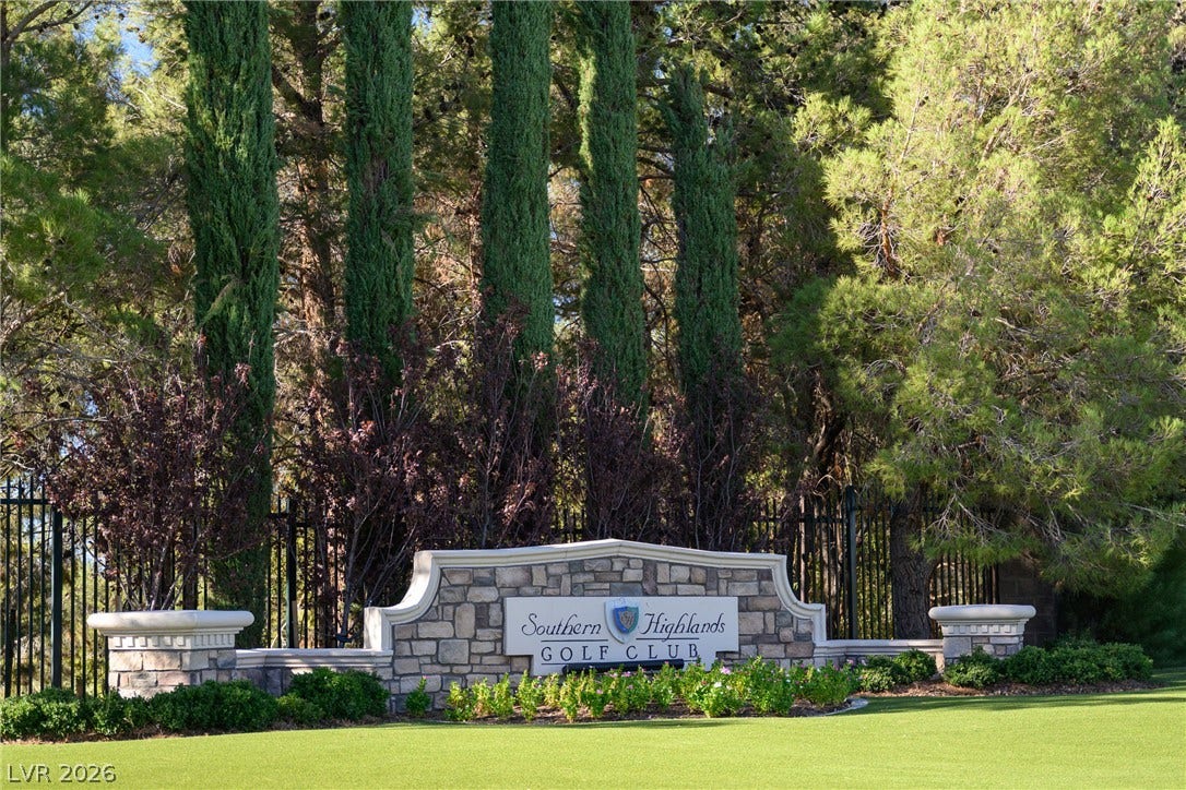 12007 Oakland Hills Drive, Las Vegas, NV 89141 Mature trees frame the stone monument sign welcoming residents to the exclusive golf club community.