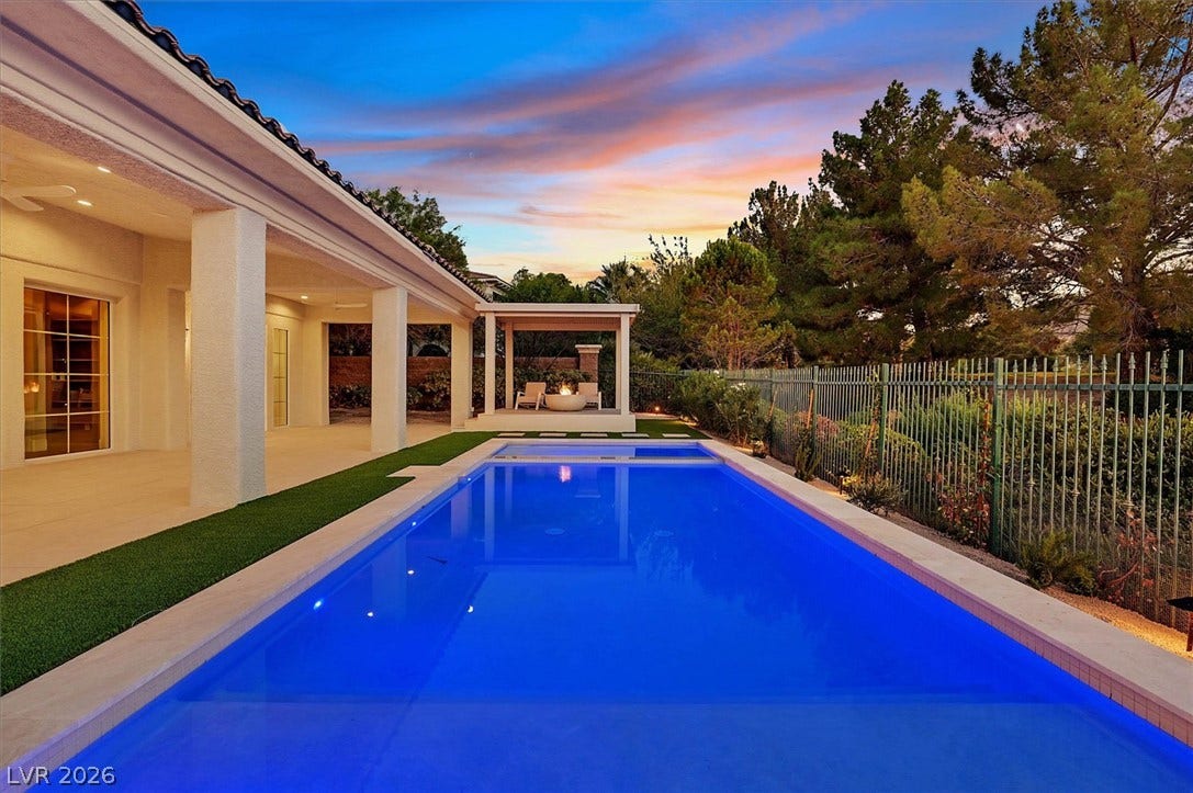 12007 Oakland Hills Drive, Las Vegas, NV 89141 An inviting swimming pool anchors this private backyard setting, bordered by a covered patio structure.