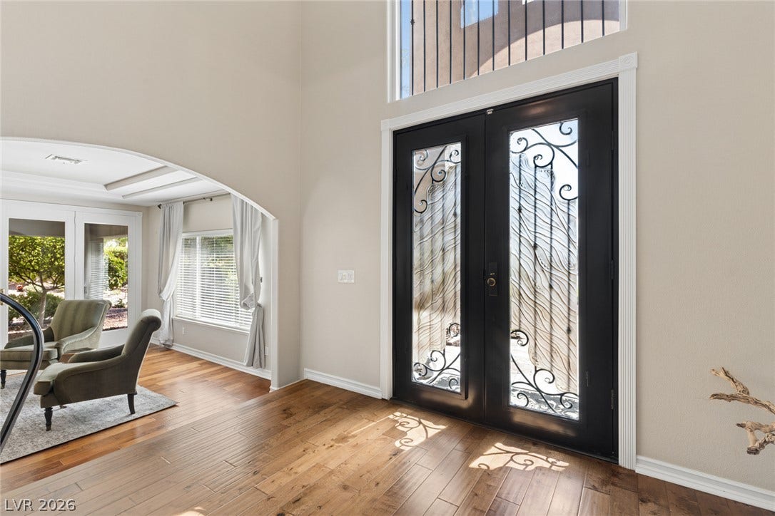 9916 Aspen Knoll Court, Las Vegas, NV 89117 Gleaming hardwood floors and a soaring ceiling frame the grand double-door entry. Door panels open for cooler Las Vegas weather.