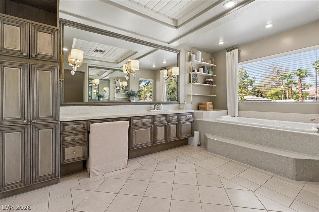 9916 Aspen Knoll Court, Las Vegas, NV 89117 Spa tub & Vanity with large mirror and make up area. Note sconces in mirror.