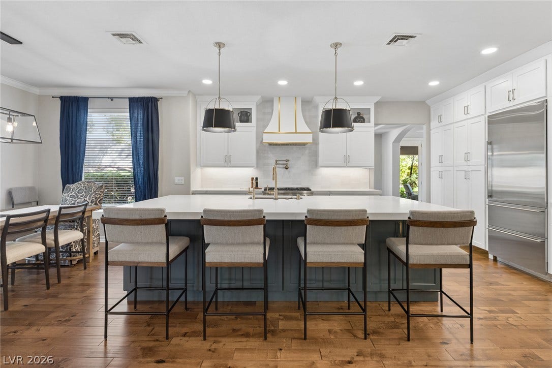 9916 Aspen Knoll Court, Las Vegas, NV 89117 Kitchen island as viewed from family room. SubZero Fridge at right. Elegant lighting and design.
