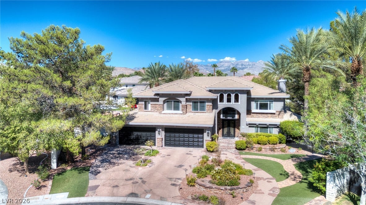 9916 Aspen Knoll Court, Las Vegas, NV 89117 Palm trees and manicured landscaping frame this exterior, set against mountain backdrops.