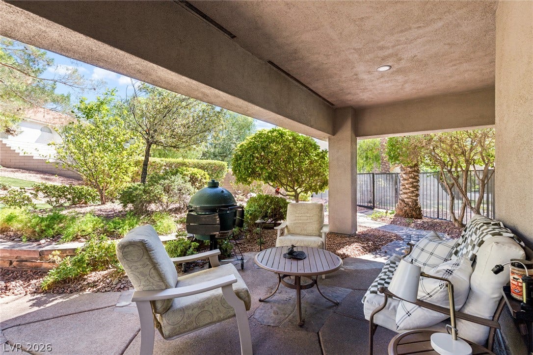 9916 Aspen Knoll Court, Las Vegas, NV 89117 An inviting covered patio offers seamless transitions from living room to a landscaped backyard retreat.