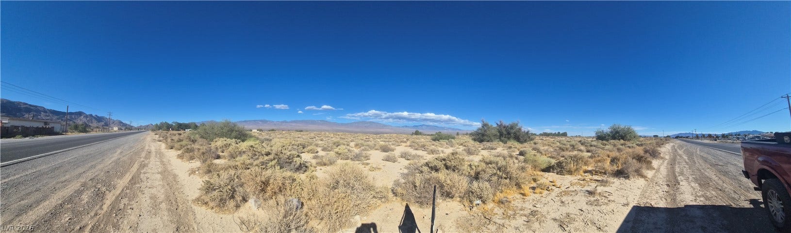 4221 N Leslie Street, Pahrump, NV 89060 A sweeping panorama captures the desert landscape under a clear blue sky.