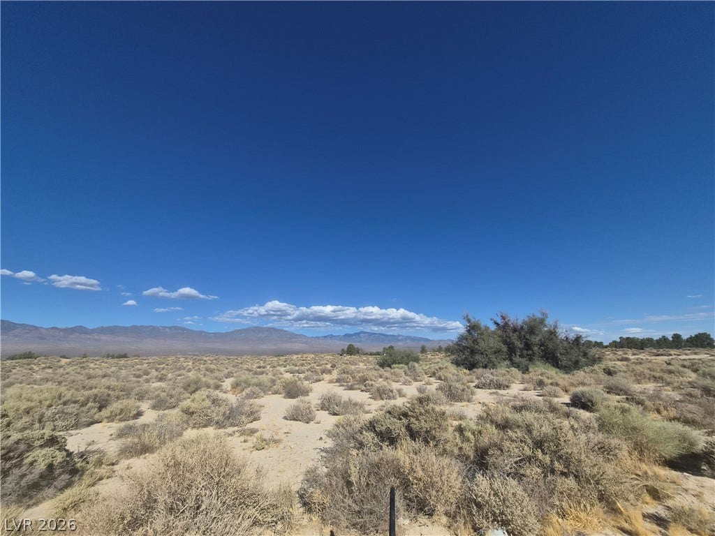 4221 N Leslie Street, Pahrump, NV 89060 Distant mountain ranges border this open desert terrain under vast clear skies.