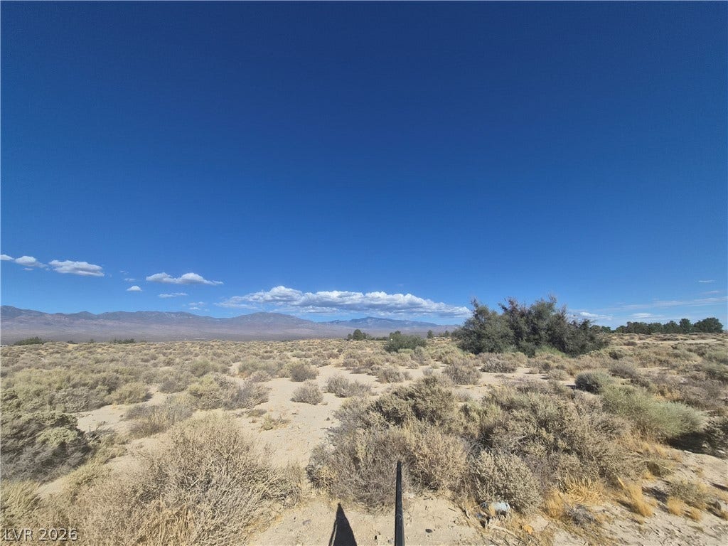 4221 N Leslie Street, Pahrump, NV 89060 Sweeping mountain vistas frame this desert landscape under a clear blue sky.