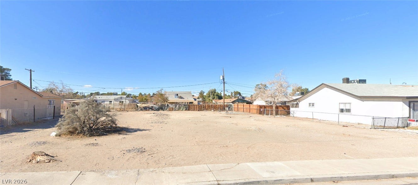 1823 Yale Street, North Las Vegas, NV 89030 An expansive level lot sits prepared for future development within a settled neighborhood.