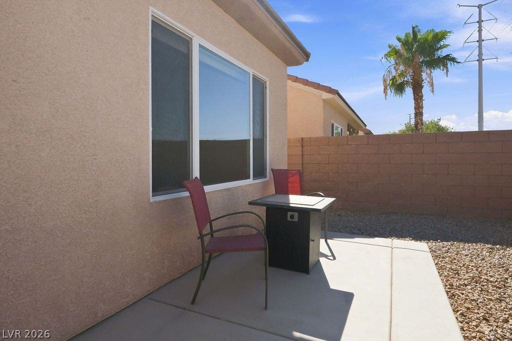 3432 Herring Gull Lane, North Las Vegas, NV 89084 Concrete patio space borders a low-maintenance gravel yard enclosed by a block privacy wall.