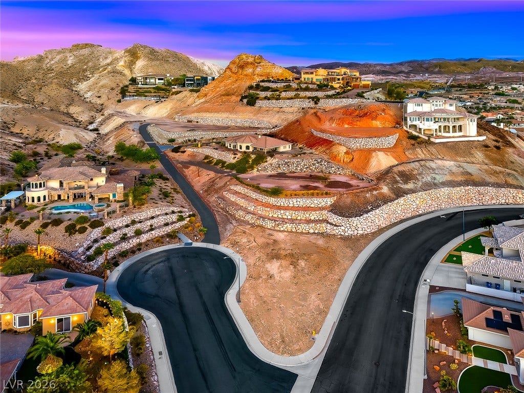 1157 Big Bird Court, Henderson, NV 89011 Dramatic hillside architecture commands attention against a striking desert mountain backdrop.