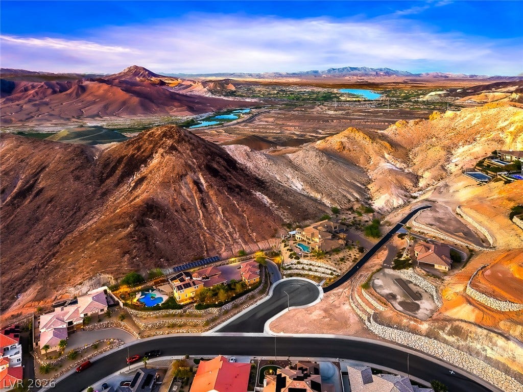 1157 Big Bird Court, Henderson, NV 89011 Dramatic mountain ridges frame panoramic valley views from this elevated desert hillside setting.