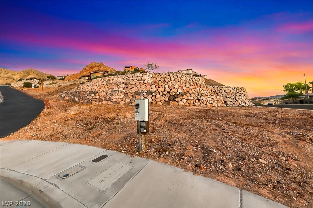 1157 Big Bird Court, Henderson, NV 89011 Dramatic desert sunsets form a scenic backdrop for this elevated lot with stone retaining walls.