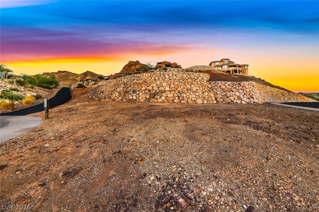1157 Big Bird Court, Henderson, NV 89011 Elevated desert building parcel features substantial stone retaining walls and panoramic hillside vistas.