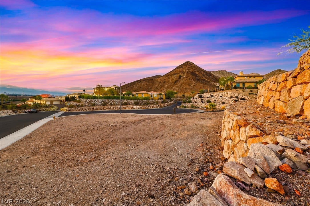 1157 Big Bird Court, Henderson, NV 89011 Dramatic mountain vistas frame this elevated lot featuring substantial stone retaining walls.