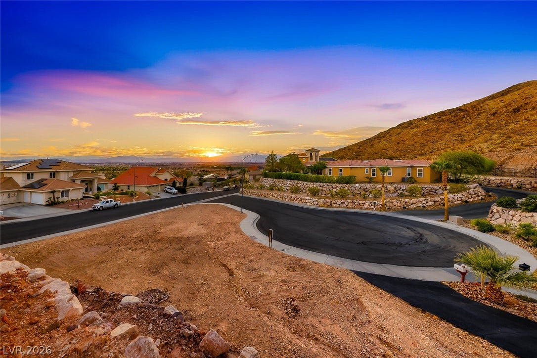 1157 Big Bird Court, Henderson, NV 89011 Panoramic mountain views and vibrant desert sunsets frame this elevated neighborhood hillside setting.