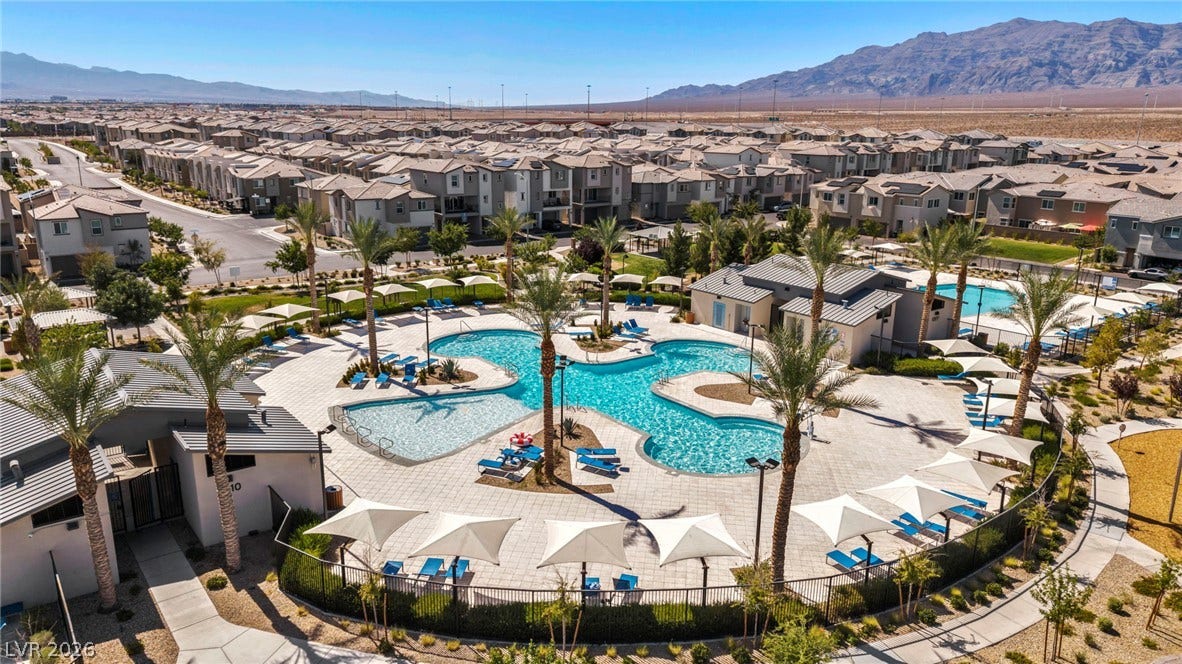 2594 Canary Yellow Court, North Las Vegas, NV 89086 A sparkling community pool offers recreation against a majestic mountain backdrop.