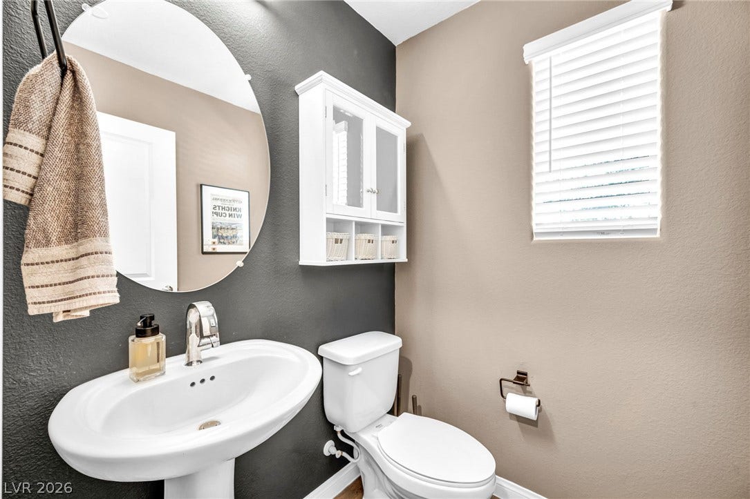 2594 Canary Yellow Court, North Las Vegas, NV 89086 Clean lines and classic fixtures define this inviting powder room.