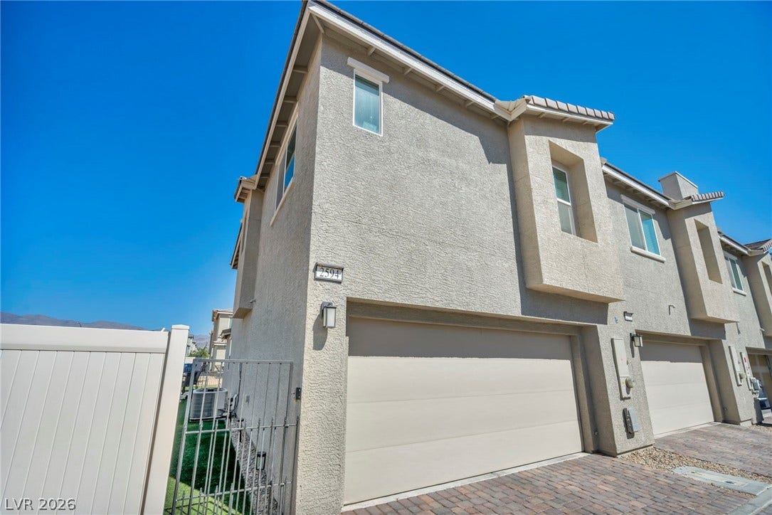 2594 Canary Yellow Court, North Las Vegas, NV 89086 Stucco exterior finishes and an attached garage define the clean architectural lines of this modern home.